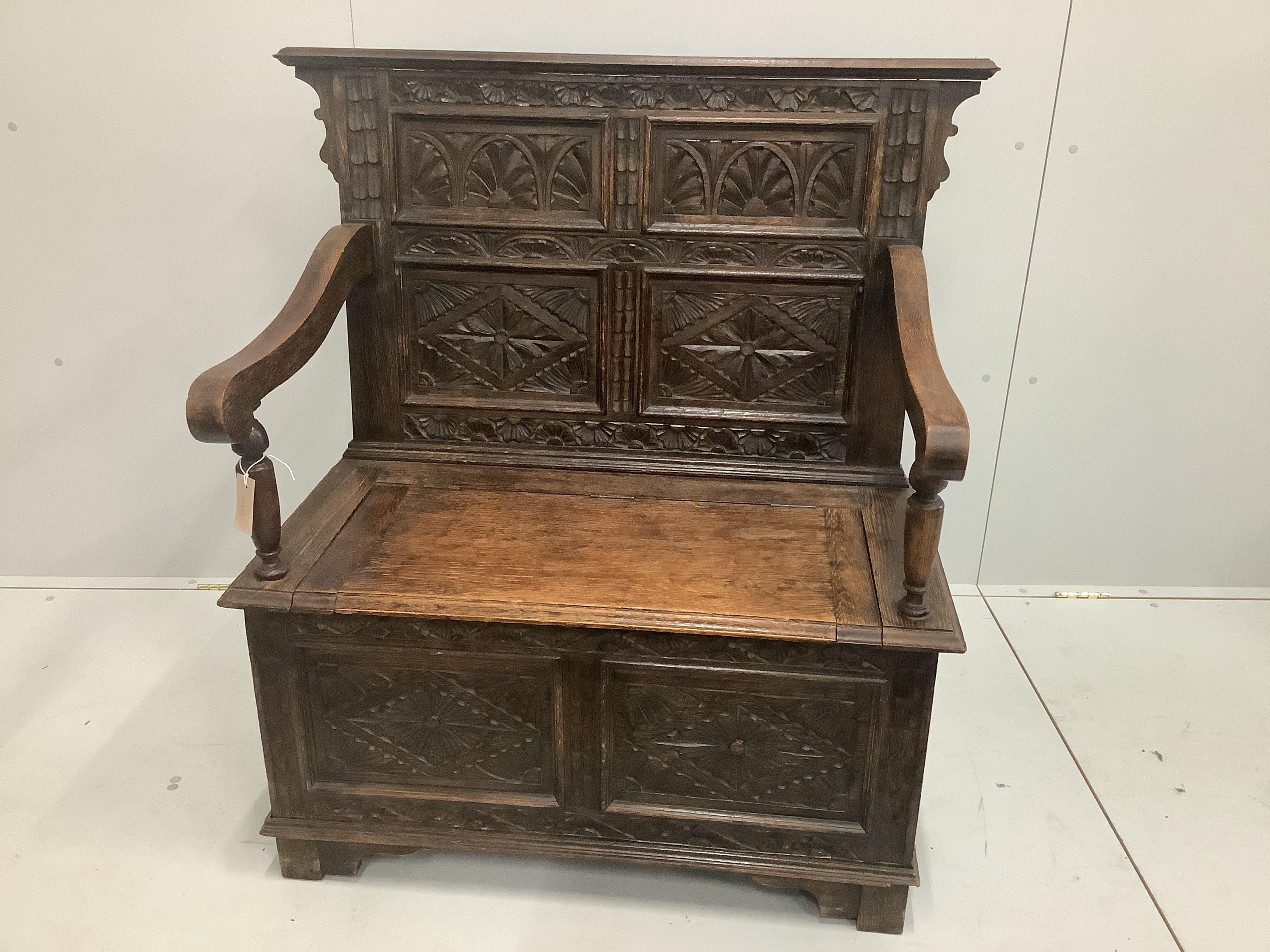 A small carved oak monk's bench, circa 1900, width 100cm, height 108cm